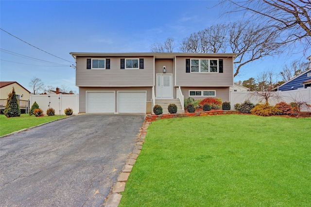 split foyer home with a front yard and a garage