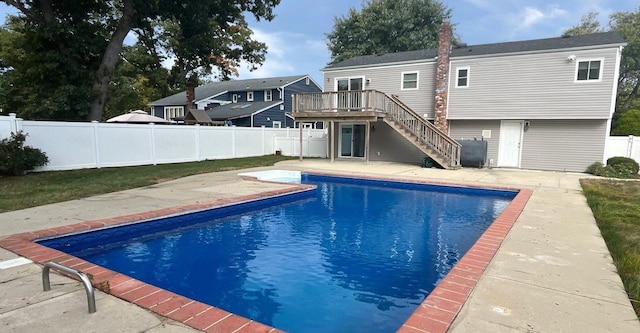 view of swimming pool with a deck and a patio area