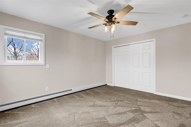 unfurnished bedroom featuring a closet, ceiling fan, carpet flooring, and a baseboard heating unit