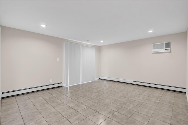 basement featuring baseboard heating, light tile patterned floors, and a wall mounted air conditioner