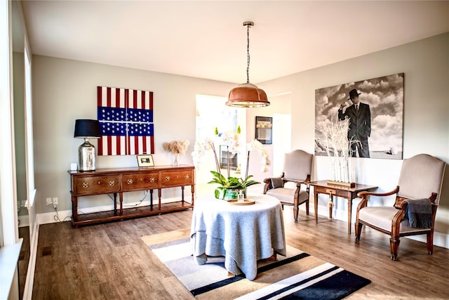 interior space with baseboards and wood finished floors