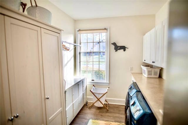 interior space featuring a wealth of natural light, cabinet space, baseboards, and wood finished floors