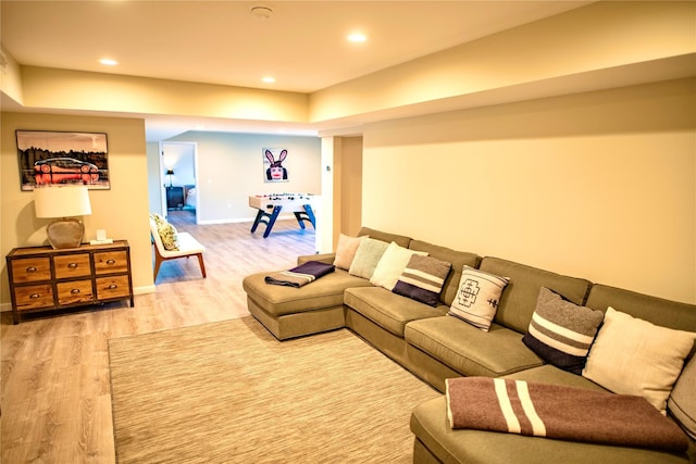 living room featuring recessed lighting, light wood-style flooring, and baseboards