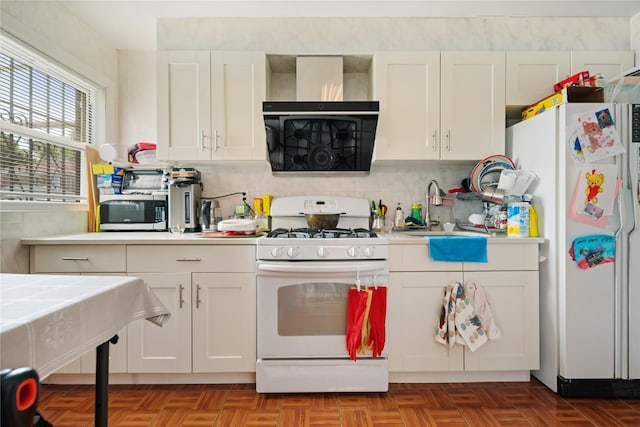 kitchen with sink, white cabinets, light parquet floors, white appliances, and tasteful backsplash