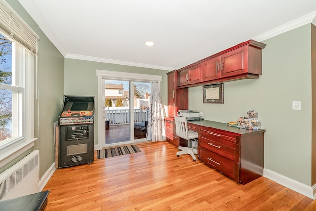 office area with ornamental molding, radiator heating unit, and light hardwood / wood-style floors