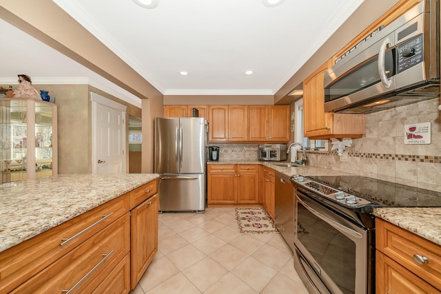 kitchen with backsplash, light tile patterned floors, light stone counters, stainless steel appliances, and crown molding