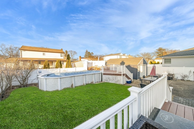 view of yard with a pool side deck