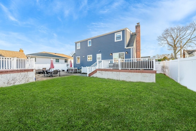 back of house with a patio area, a lawn, and a deck