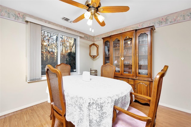 dining area featuring ceiling fan and light wood-type flooring