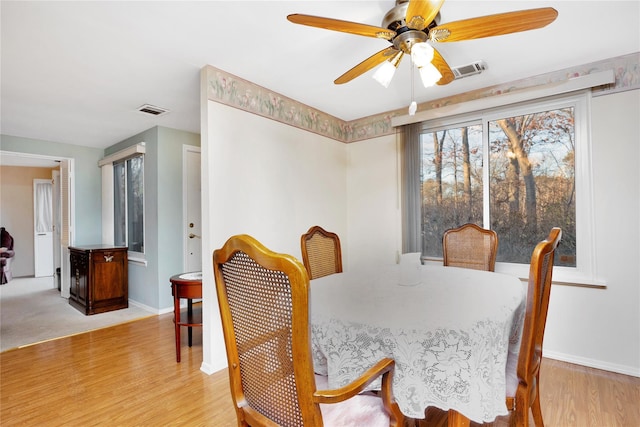 dining room with ceiling fan and light hardwood / wood-style flooring