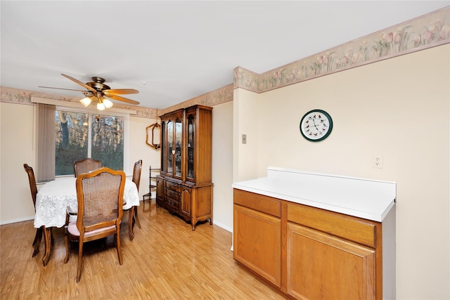 dining room with ceiling fan and light hardwood / wood-style flooring