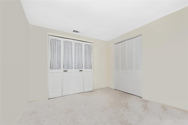 unfurnished bedroom with light carpet