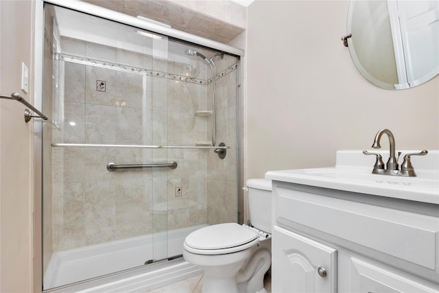 bathroom featuring walk in shower, vanity, and toilet