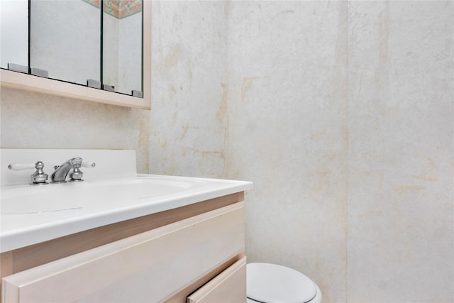 bathroom with toilet and vanity