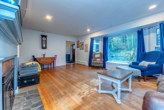 living room with wood-type flooring and baseboard heating