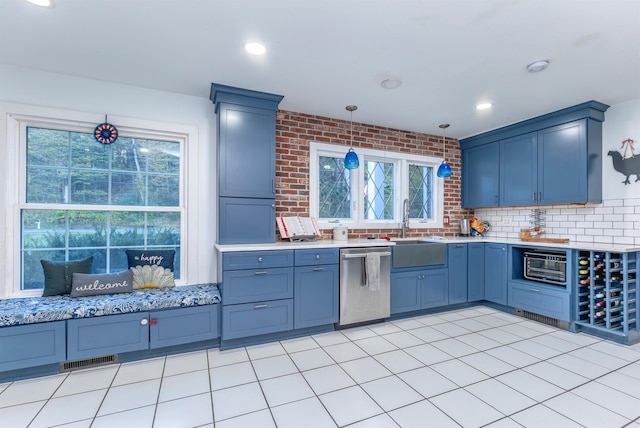 kitchen with light tile patterned flooring, sink, tasteful backsplash, stainless steel dishwasher, and pendant lighting