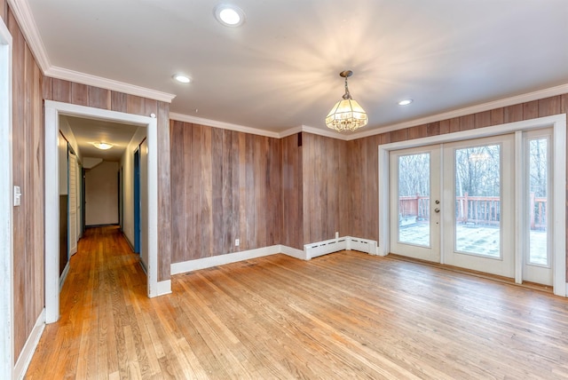 spare room featuring hardwood / wood-style flooring, ornamental molding, and french doors