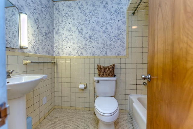 full bathroom with sink, tile walls, tile patterned flooring, plus walk in shower, and toilet