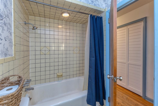 bathroom with wood-type flooring and shower / bathtub combination with curtain