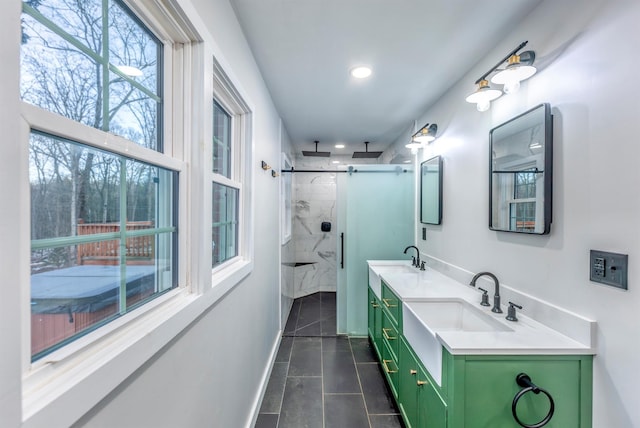 bathroom with a shower with door, vanity, and tile patterned flooring