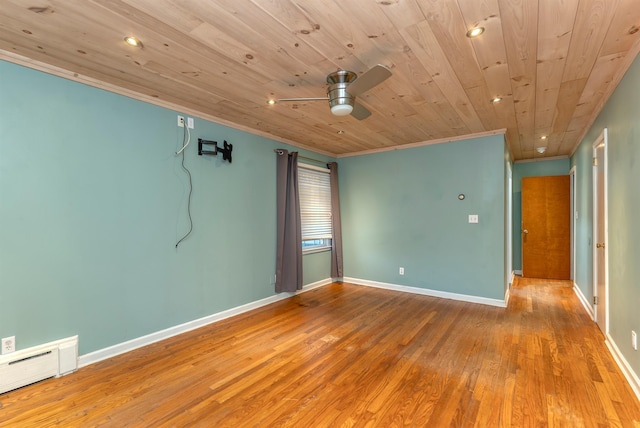 empty room featuring hardwood / wood-style floors, a baseboard heating unit, ceiling fan, wood ceiling, and crown molding