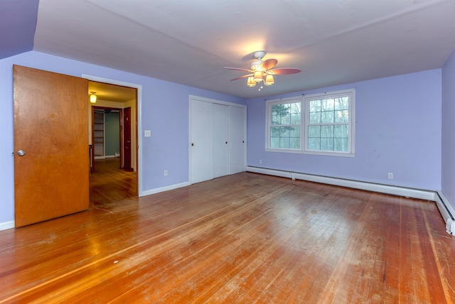 unfurnished room featuring ceiling fan, a baseboard radiator, and wood-type flooring