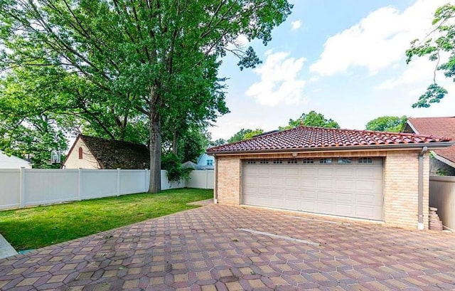 garage featuring a lawn