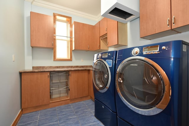 laundry area with cabinets, ornamental molding, and washer and dryer