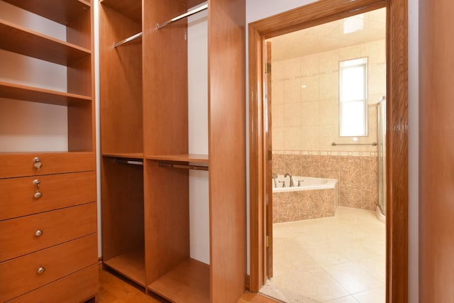 spacious closet with light tile patterned floors