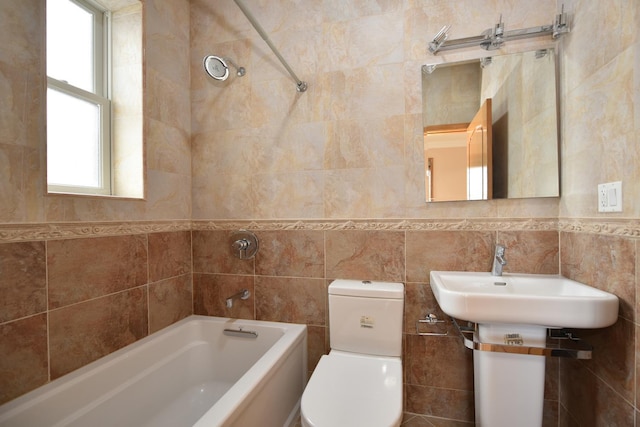 full bathroom with tile walls, sink, shower / tub combination, and toilet