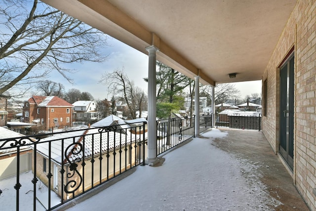 view of snow covered back of property