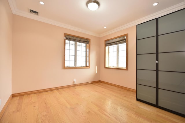 unfurnished bedroom with ornamental molding and light hardwood / wood-style floors