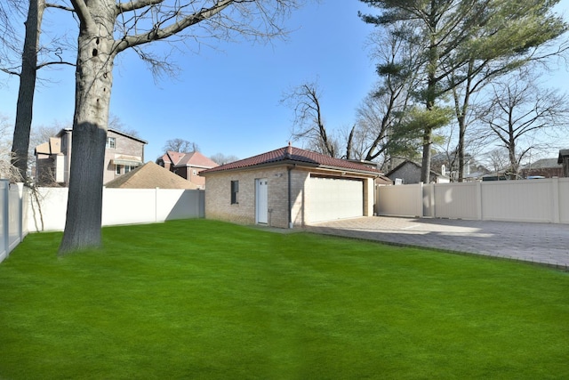 view of yard with a garage and an outdoor structure