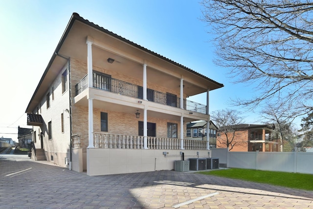 back of house with cooling unit and a balcony