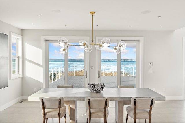 dining space with plenty of natural light and a water view