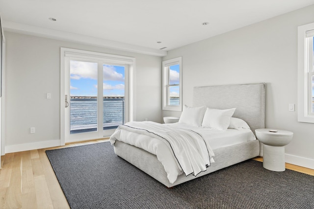 bedroom featuring hardwood / wood-style flooring and access to outside