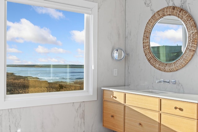 bathroom with plenty of natural light, vanity, and a water view