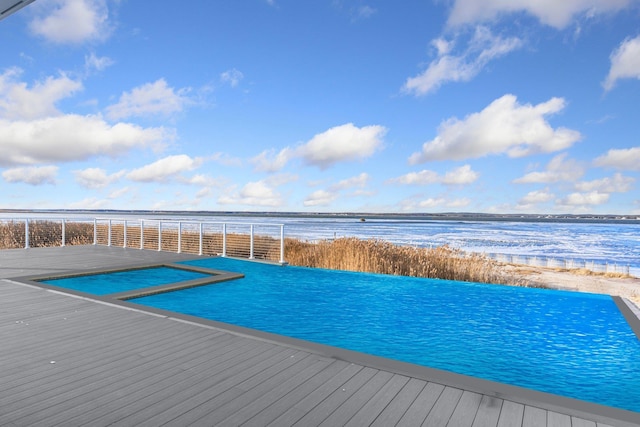 view of swimming pool featuring a water view