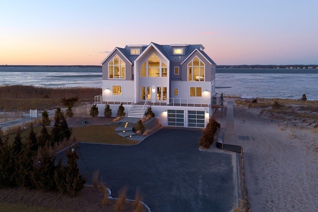 view of front of house featuring a garage and a water view