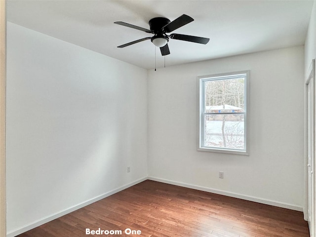 spare room featuring ceiling fan and dark hardwood / wood-style floors