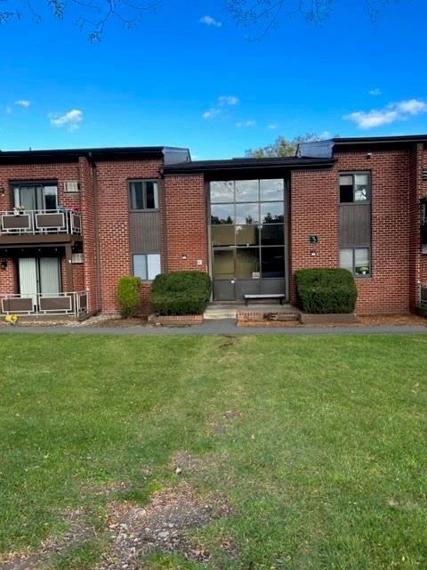 rear view of property with a lawn