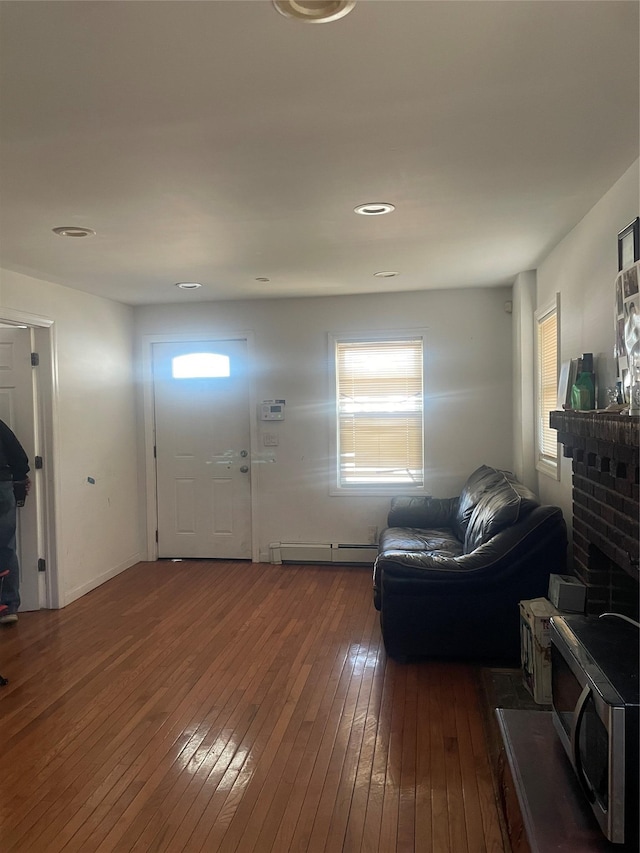 entryway with hardwood / wood-style floors and a baseboard radiator