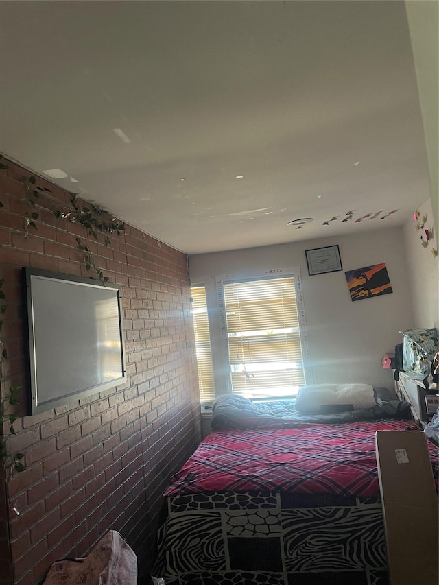 bedroom with brick wall