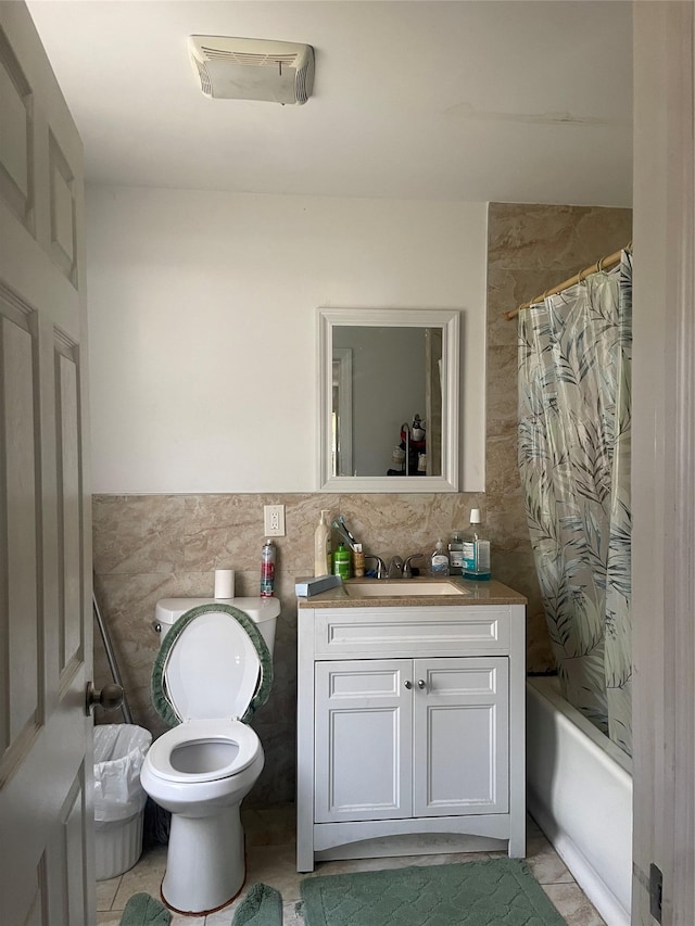 full bath featuring shower / tub combo with curtain, tile walls, visible vents, toilet, and vanity