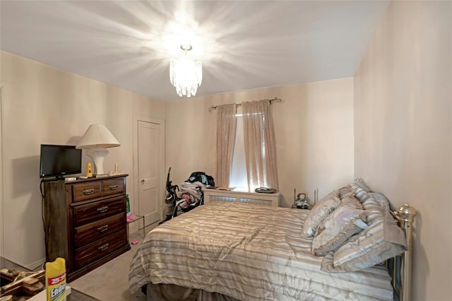 bedroom featuring carpet flooring and a notable chandelier