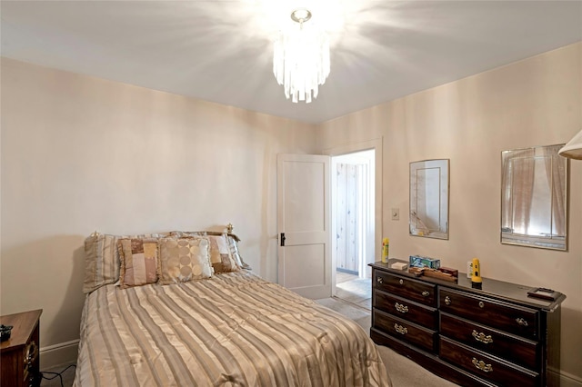 carpeted bedroom with a chandelier