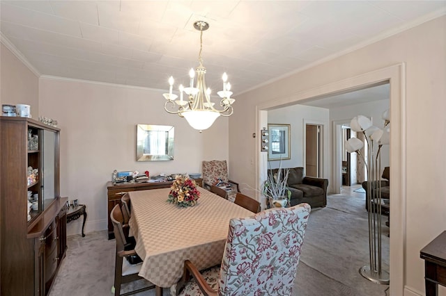 carpeted dining room featuring crown molding and an inviting chandelier