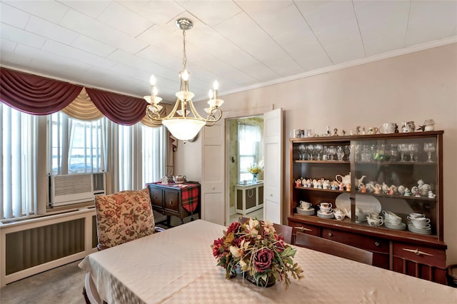 carpeted dining area with ornamental molding, cooling unit, and radiator