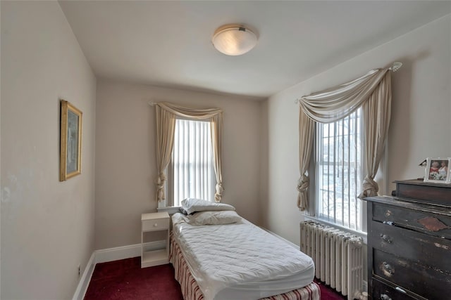 carpeted bedroom with radiator heating unit