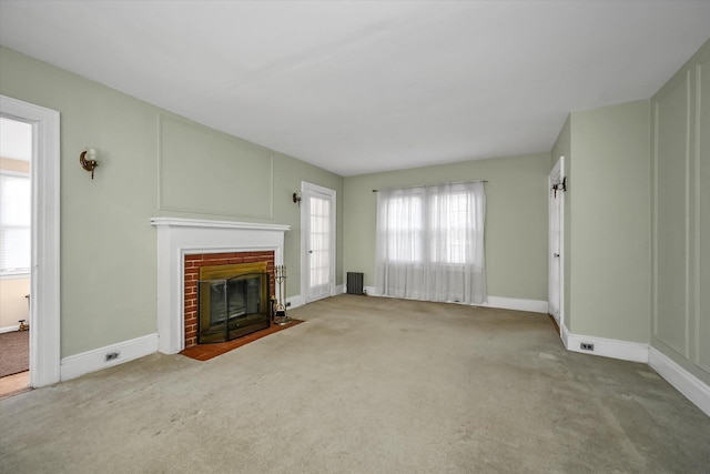 unfurnished living room featuring light colored carpet and a fireplace